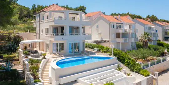 Modern white villa with swimming pool in Croatia, coastal vacation home.