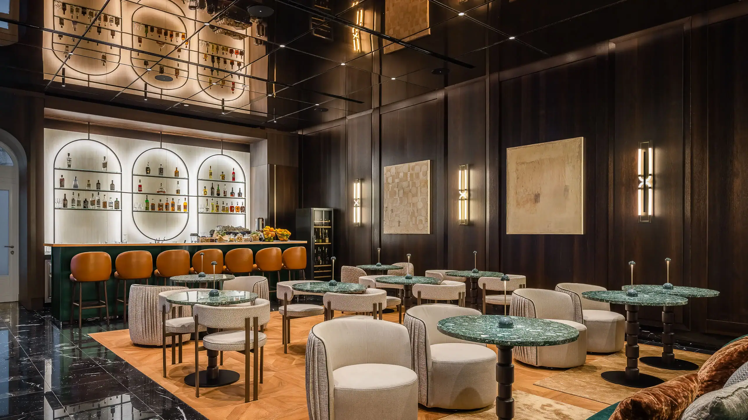 Elegant hotel bar with modern design, plush seating, and ambient lighting.